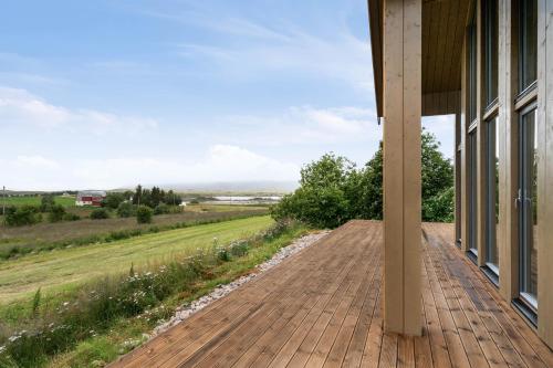 a porch of a house with a view of a field at Hoven Lodge in Vik
