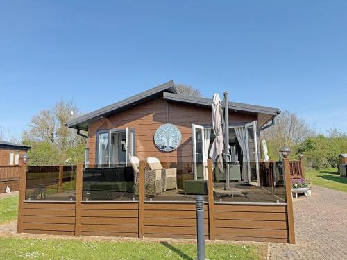 a house with a fence in front of it at Staying Inn in West Mersea