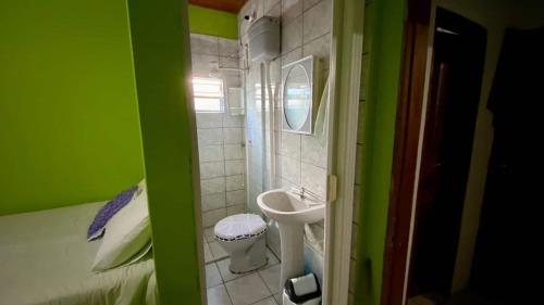 a small bathroom with a sink and a toilet at Quarto Oliveira in Ibicoara