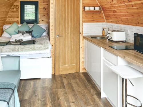 a small kitchen with a bed in a tiny house at Arran - Uk48415 in Dalry
