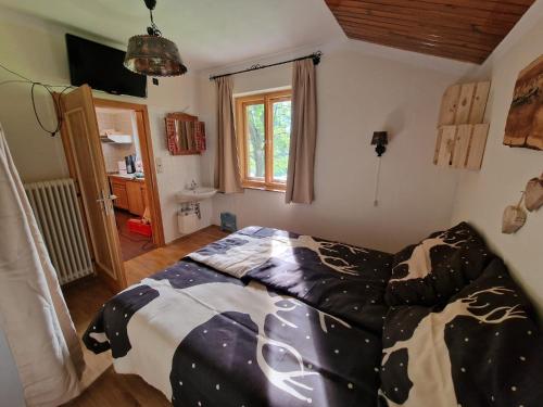 a bedroom with a bed with a comforter on it at Ferienhaus Teichalm in Lantsch