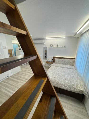 a small bedroom with a bed and a staircase at Seoul Mansion Guesthouse in Seoul