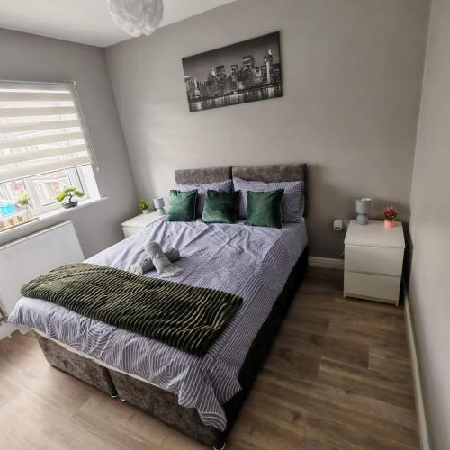 a bedroom with a bed with a teddy bear on it at Modern 2 bedroom house, sleeps 5 guests, Free parking in Hull