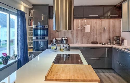 a kitchen with a wooden island in the middle at Beautiful Apartment In Fredrikstad in Fredrikstad