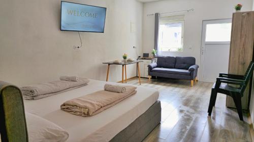 a living room with two beds and a chair at Cozy Studio Apartment In The Black Forest in Villingen-Schwenningen