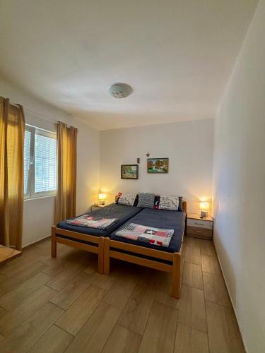 a bedroom with a bed and two lamps on the floor at Villa Marko in Sutomore