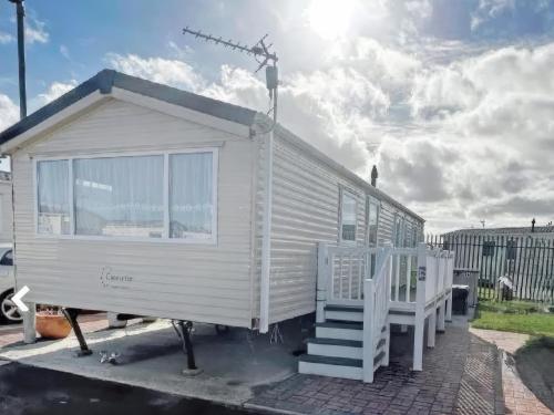 a small white tiny house with a staircase at Europa Caernarfon - Ukc9633 in Rowen