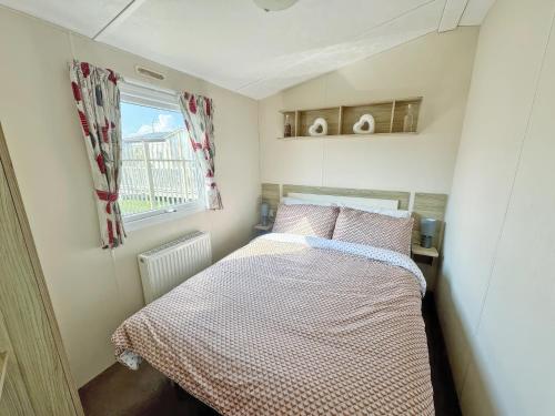 a small bedroom with a bed and a window at Europa Caernarfon - Ukc9633 in Rowen