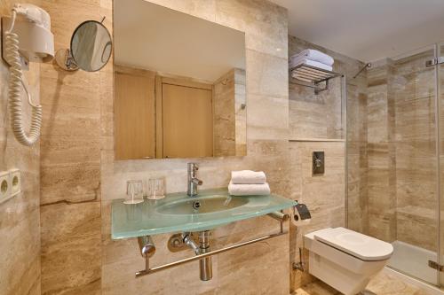 a bathroom with a sink and a toilet at Grupotel Dunamar in Can Picafort