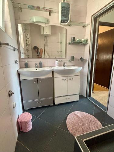 a bathroom with two sinks and a mirror at Villa Marko in Sutomore