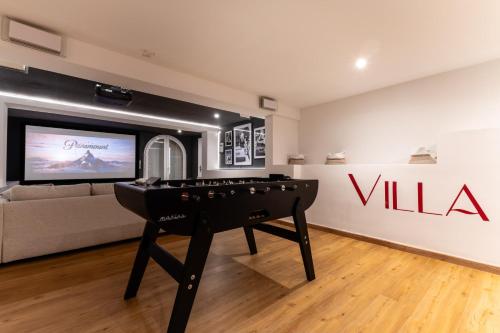 a living room with a pool table in front of a wall at Villa Halo Lagoon Pool & Exclusive seaside getaway in Cap d'Agde