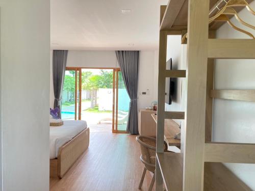 a bedroom with a bed and a bunk bed at Monanza Hotel in Ban Thung Prong