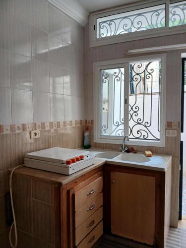 a kitchen with a sink and a window at Appartement S2 Hammamet Centre in Hammamet