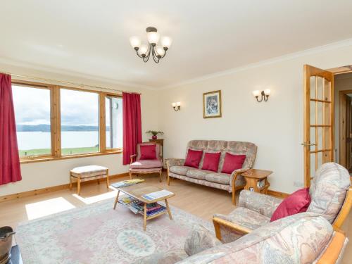 a living room with two couches and a table at Ach-Na-Clachan in Gairloch