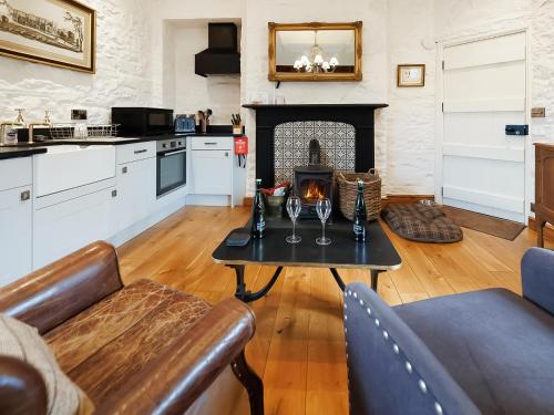 a living room with a table and a fireplace at The Tower - Uk46652 in Crickhowell