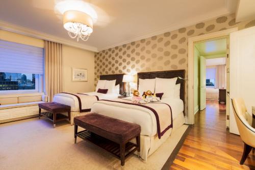 a bedroom with two beds with two teddy bears on them at The Ritz-Carlton, Montreal in Montreal