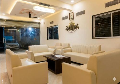 a waiting room with couches and a table at Raj Royal Hotel in Nagpur