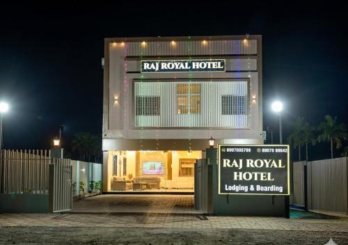 a hotel with a sign in front of it at night at Raj Royal Hotel in Nagpur