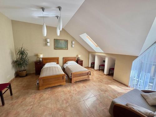 a large bedroom with two beds in a attic at Classic Car Museum Apartment in Riga