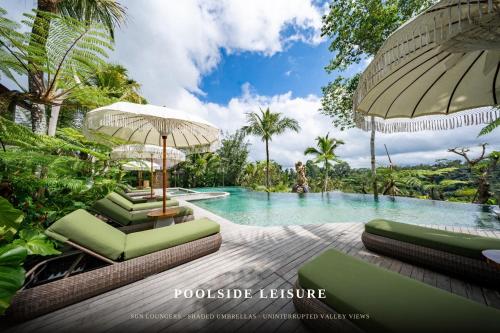 a pool with chaise lounge chairs and an umbrella at ULU Valley Retreat in Tegalalang