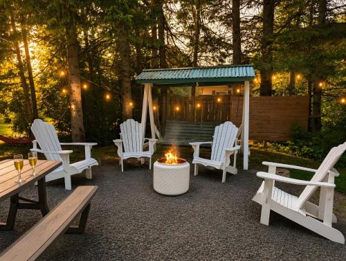 a group of chairs and a fire pit with a gazebo at Chic Shack with spa - near Massif Charlevoix & MSA in Saint-Tite-des-Caps