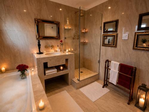 a bathroom with a shower and a sink and a tub at Goblin's Mead in Edgemead