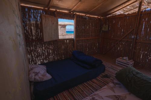 a small room with two beds and a window at Eden Camp Abu Galum in Dahab