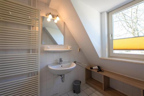 a bathroom with a sink and a window at FeWo-Dierhagen in Prerow