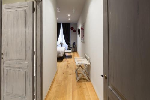 a hallway with a room with a bed and a door at Il Duomo Luxury Suite in Pietrasanta