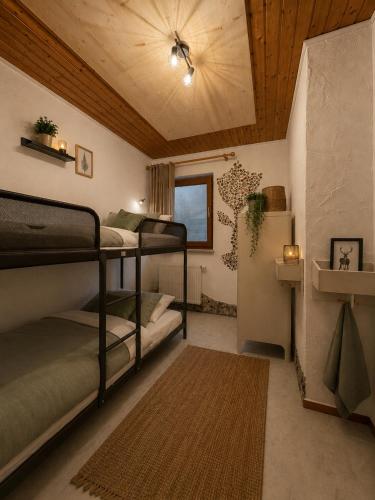 a room with two bunk beds and a ceiling at Chalet Zugspitzblick in Lermoos