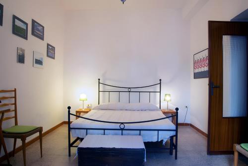 a bedroom with a bed and two chairs in it at Casa Zolesiop in SantʼAnna Arresi