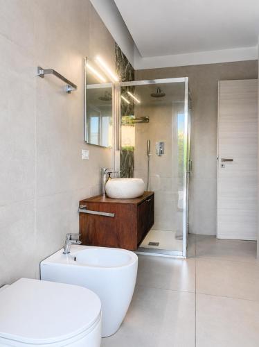 a bathroom with a sink and a toilet and a shower at SottoSopra Tropea in Tropea