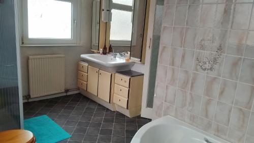 a bathroom with a sink and a mirror at House near beach in Port Talbot