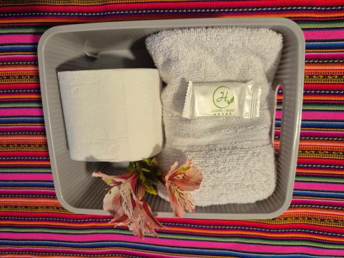 a gray box with towels and a towel at VittoriaHouse in Ollantaytambo