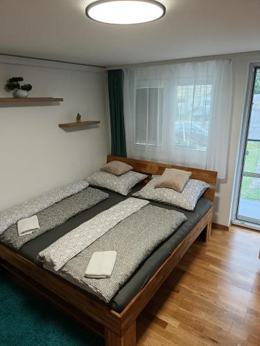 a bedroom with two beds and a large window at Apartmán Forst in Nová Lesná