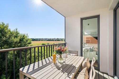 a patio table with flowers on a balcony at Ferienwohnung Seaside App 9 List auf Sylt in List