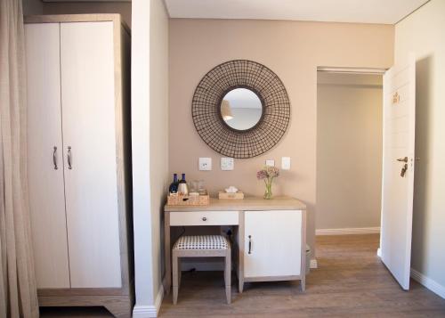 a dressing room with a table and a mirror at Aquila Private Game Reserve & Spa in Touwsrivier