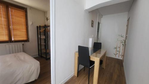 a bedroom with a desk and a bed and a desk and a chair at Chambre 8 in Le Trait