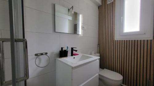 a white bathroom with a sink and a toilet at Chambre 8 in Le Trait