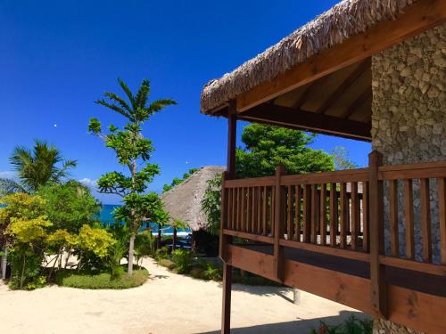 a porch of a resort with a view of the ocean at Tanna Evergreen Resort & Tours in Tanna Island