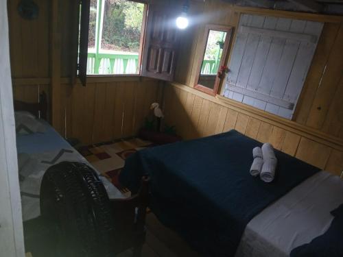 a room with a bed with white shoes on it at Hospedagem coqueioros in Soure