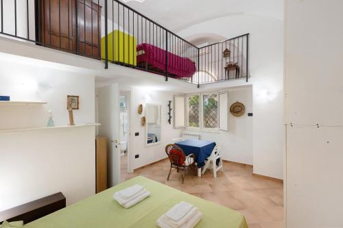a living room with a table and a staircase at Appartamento Anna in Meta