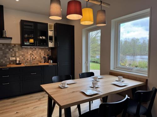 a dining room with a wooden table and a window at Lake House Rågeboda in Södra Rågeboda