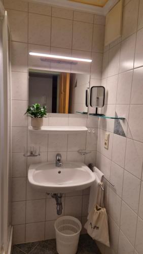 a bathroom with a white sink and a mirror at Fliana Arlberg Studios - Apartments in Sankt Anton am Arlberg