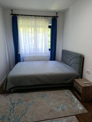 a bedroom with a bed and a window at Virgin Forest D&A in Gornja Presjenica