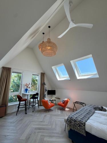 a bedroom with a bed and a table and chairs at Mel's Pintxos winebar & Aparthotel in Zandvoort