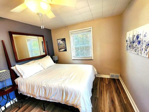 a bedroom with a bed and a window at 513Company - Hometown +Location in Cincinnati