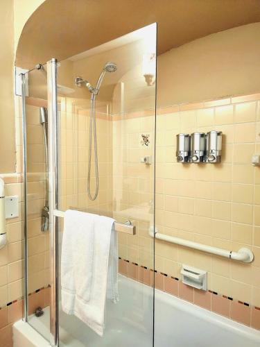 a shower with a glass door in a bathroom at 513Company - Hometown +Location in Cincinnati
