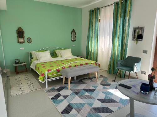 a bedroom with a bed and a table and a chair at Casa verde in Tuzla