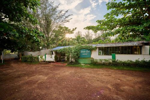 a house with a dirt road in front of it at Treebo Lands End Beach Resort - 100m From Morjim Beach in Morjim